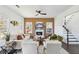 A spacious living room featuring stylish decor, dark wood floors, a fireplace, and black stairs at 2395 Saint James Nw Dr, Atlanta, GA 30318