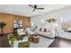 A spacious living room featuring stylish decor, dark wood floors, fireplace, and ceiling fan at 2395 Saint James Nw Dr, Atlanta, GA 30318