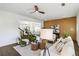 A spacious living room featuring stylish decor, dark wood floors, a fireplace, and open kitchen area at 2395 Saint James Nw Dr, Atlanta, GA 30318