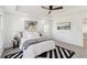 Tranquil main bedroom with a tray ceiling, ceiling fan, a black and white rug, and large windows at 2395 Saint James Nw Dr, Atlanta, GA 30318