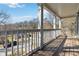 View of the wood porch featuring classic white pillars and railings, offering an inviting outdoor space at 2395 Saint James Nw Dr, Atlanta, GA 30318