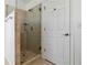 Tiled shower with a glass enclosure, complemented by neutral walls and a convenient towel rack at 2395 Saint James Nw Dr, Atlanta, GA 30318