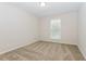 This bedroom features neutral walls, carpet, and a bright window at 2695 Trotters Walk Trl, Snellville, GA 30078