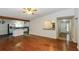 Open-concept living room with hardwood floors connecting to the kitchen and entryway at 2695 Trotters Walk Trl, Snellville, GA 30078