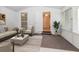 The sunroom features an open doorway, indoor greenery, and modern furniture at 2695 Trotters Walk Trl, Snellville, GA 30078