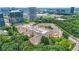An aerial view of an apartment complex surrounded by trees with city buildings in the background at 10 Perimeter Summit Ne Br # 2312, Atlanta, GA 30319