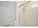 Bright bathroom showcasing a walk-in shower with beige tiling and glass enclosure at 10 Perimeter Summit Ne Br # 2312, Atlanta, GA 30319