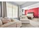 Comfortable bedroom featuring cozy seating area and a plush bed against a red accent wall at 10 Perimeter Summit Ne Br # 2312, Atlanta, GA 30319
