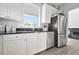 Charming kitchen featuring white cabinets, stainless steel appliances, and a dark countertop at 10 Perimeter Summit Ne Br # 2312, Atlanta, GA 30319