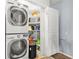 A laundry closet with stacked washer dryer and organized shelving at 10 Perimeter Summit Ne Br # 2312, Atlanta, GA 30319