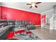 Comfortable living room with gray leather sofa, accent rug, and modern glass coffee table, plus stylish red accent wall at 10 Perimeter Summit Ne Br # 2312, Atlanta, GA 30319