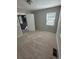 Neutral bedroom with carpeted floors, light walls, and a bright window with blinds at 1457 Richland Road Southwest Sw Rd, Atlanta, GA 30310