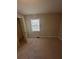 A neutral-toned bedroom with a window, carpeted floors, and ample natural light at 1457 Richland Road Southwest Sw Rd, Atlanta, GA 30310