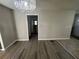 An open-concept living space with modern light fixture and flooring in neutral tones at 1457 Richland Road Southwest Sw Rd, Atlanta, GA 30310