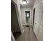 Hallway with modern floors and neutral walls that leads to the bathroom at 1457 Richland Road Southwest Sw Rd, Atlanta, GA 30310