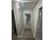 Hallway featuring modern flooring and neutral walls with views to the living room at 1457 Richland Road Southwest Sw Rd, Atlanta, GA 30310