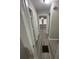 A gray hallway features new flooring and fresh paint, leading to a sunlit living area with chandelier at 1457 Richland Road Southwest Sw Rd, Atlanta, GA 30310