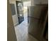 A functional kitchen area featuring a stainless steel refrigerator and a view towards the exit door at 1457 Richland Road Southwest Sw Rd, Atlanta, GA 30310