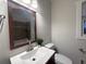 Bathroom with an updated sink, mirror and fixtures, and a view of the tiled tub surround at 1647 Walker Ave, Atlanta, GA 30337