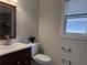 Bathroom with an updated sink, mirror and fixtures, and a view of the tiled tub surround at 1647 Walker Ave, Atlanta, GA 30337