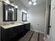 Double vanity bathroom with dual sinks, mirrors, and decorative lighting at 1647 Walker Ave, Atlanta, GA 30337