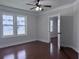 Bedroom featuring hardwood floors, a ceiling fan, large windows, and a neutral color scheme at 1647 Walker Ave, Atlanta, GA 30337