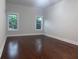 Bright bedroom with hardwood floors and natural light from two windows at 1647 Walker Ave, Atlanta, GA 30337