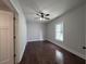 Bedroom featuring hardwood floors, a ceiling fan, a large window, and a neutral color scheme at 1647 Walker Ave, Atlanta, GA 30337