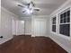 Bedroom featuring hardwood floors, a ceiling fan, large windows, a closet, and a neutral color scheme at 1647 Walker Ave, Atlanta, GA 30337