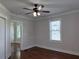Bedroom featuring hardwood floors, a ceiling fan, a large window, and a neutral color scheme at 1647 Walker Ave, Atlanta, GA 30337