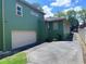Green home exterior with driveway, garage and fenced side yard at 1647 Walker Ave, Atlanta, GA 30337