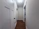 Long hallway with hardwood floors, white trim, doors, and light gray walls at 1647 Walker Ave, Atlanta, GA 30337