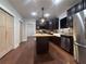Stylish kitchen with dark cabinets, butcher block island, stainless appliances, and wood floors at 1647 Walker Ave, Atlanta, GA 30337