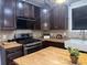 Modern kitchen with butcher block countertops, stainless steel appliances, and dark cabinets at 1647 Walker Ave, Atlanta, GA 30337