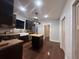 Stylish kitchen with dark cabinets, butcher block island, stainless appliances, and wood floors at 1647 Walker Ave, Atlanta, GA 30337