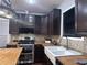 Modern kitchen with butcher block countertops, stainless steel appliances, and dark cabinets at 1647 Walker Ave, Atlanta, GA 30337