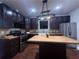 Modern kitchen featuring dark cabinets, stainless steel appliances, and a center island at 1647 Walker Ave, Atlanta, GA 30337