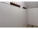 Mudroom featuring white wood paneled walls, coat hooks, trim, and neutral flooring at 1647 Walker Ave, Atlanta, GA 30337