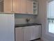 Pantry with light wood cabinets, dark countertop, and a white refrigerator at 1647 Walker Ave, Atlanta, GA 30337