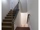 View of the staircase with neutral walls and ornamental iron and wood banister at 1647 Walker Ave, Atlanta, GA 30337