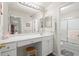 Bright bathroom with vanity, stool, and glass-enclosed shower at 620 Granville Ct, Sandy Springs, GA 30328