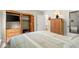 Spacious bedroom featuring a bed, built-in shelves, and ample storage with natural light from the window at 620 Granville Ct, Sandy Springs, GA 30328