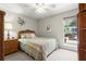 Cozy bedroom with a queen-size bed, wicker furniture, and a view of greenery outside the window at 620 Granville Ct, Sandy Springs, GA 30328