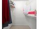 Walk-in closet with clothes hanging on racks and a bag from Swoozie's on the shelf at 620 Granville Ct, Sandy Springs, GA 30328
