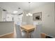 Cozy dining area features a wooden table, four chairs, and modern lighting fixture with a mirror on the wall at 620 Granville Ct, Sandy Springs, GA 30328