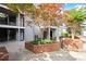 Building with brick accents, mature trees, and outdoor patio with seating at 620 Granville Ct, Sandy Springs, GA 30328