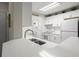 Bright kitchen features white cabinets, stainless steel sink, and modern appliances for convenient cooking at 620 Granville Ct, Sandy Springs, GA 30328
