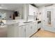 Modern kitchen with white cabinetry, stainless steel appliances, and a breakfast bar overlooking the living area at 620 Granville Ct, Sandy Springs, GA 30328