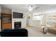 Open concept living room featuring a fireplace, flat screen television, and open access to the kitchen at 620 Granville Ct, Sandy Springs, GA 30328
