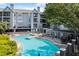 Beautiful pool area with plenty of chairs for relaxing, surrounded by well-maintained landscaping at 620 Granville Ct, Sandy Springs, GA 30328